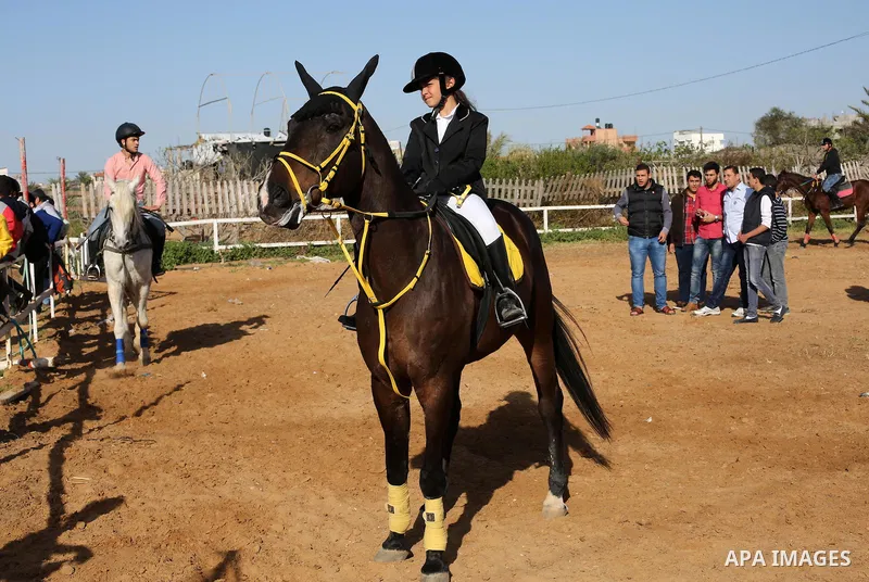 Palestinian horse riders take part in a jumping competition in Gaza city on March 11, 2016. Photo by Mohammed Asad