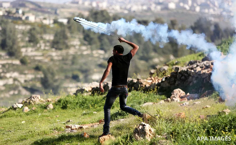 Palestinian protesters clash with Israeli security forces on March 11, 2016, following a demonstration in solidarity with Palestinian prisoners held in Israeli jails, outside the compound of the Israeli-run Ofer prison n...