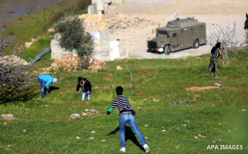 Palestinian protesters clash with Israeli security forces on March 11, 2016, following a demonstration in solidarity with Palestinian prisoners held in Israeli jails, outside the compound of the Israeli-run Ofer prison n...