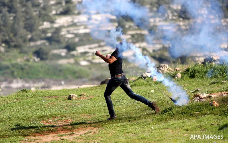 Palestinian protesters clash with Israeli security forces on March 11, 2016, following a demonstration in solidarity with Palestinian prisoners held in Israeli jails, outside the compound of the Israeli-run Ofer prison n...
