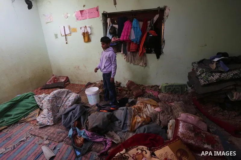 A Palestinian boy inspects a bedroom of the damaged Khussa family home after an Israeli strike on Hamas bases in Beit Lahiya, northern Gaza strip on March 12, 2016. Israeli planes struck Hamas bases in the Gaza Strip ear...