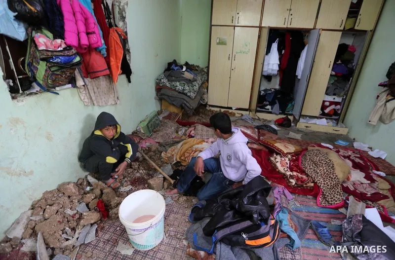 Palestinian boys inspect a bedroom of the damaged Khussa family home after an Israeli strike on Hamas bases in Beit Lahiya, northern Gaza strip on March 12, 2016. Israeli planes struck Hamas bases in the Gaza Strip early...