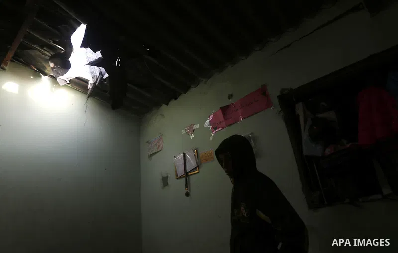 A Palestinian boy inspects a bedroom of the damaged Khussa family home after an Israeli strike on Hamas bases in Beit Lahiya, northern Gaza strip on March 12, 2016. Israeli planes struck Hamas bases in the Gaza Strip ear...