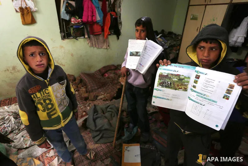 Palestinian boys inspect a bedroom of the damaged Khussa family home after an Israeli strike on Hamas bases in Beit Lahiya, northern Gaza strip on March 12, 2016. Israeli planes struck Hamas bases in the Gaza Strip early...
