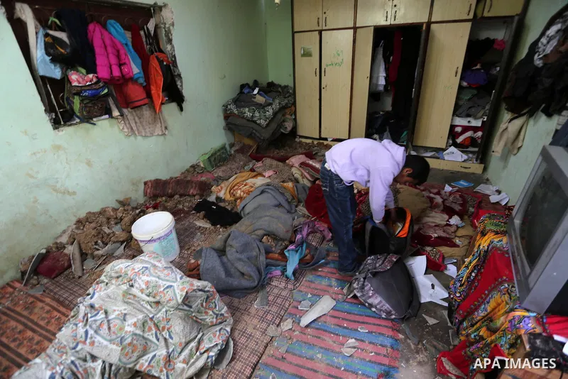 A Palestinian boy inspects a bedroom of the damaged Khussa family home after an Israeli strike on Hamas bases in Beit Lahiya, northern Gaza strip on March 12, 2016. Israeli planes struck Hamas bases in the Gaza Strip ear...