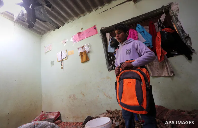 A Palestinian boy inspects a bedroom of the damaged Khussa family home after an Israeli strike on Hamas bases in Beit Lahiya, northern Gaza strip on March 12, 2016. Israeli planes struck Hamas bases in the Gaza Strip ear...