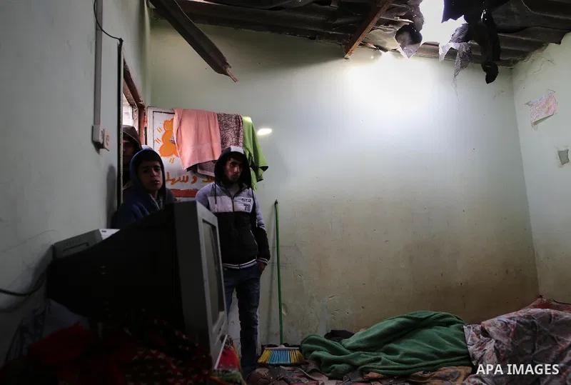 Palestinian boys inspect a bedroom of the damaged Khussa family home after an Israeli strike on Hamas bases in Beit Lahiya, northern Gaza strip on March 12, 2016. Israeli planes struck Hamas bases in the Gaza Strip early...