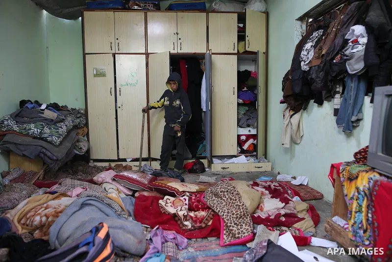 A Palestinian boy inspects a bedroom of the damaged Khussa family home after an Israeli strike on Hamas bases in Beit Lahiya, northern Gaza strip on March 12, 2016. Israeli planes struck Hamas bases in the Gaza Strip ear...