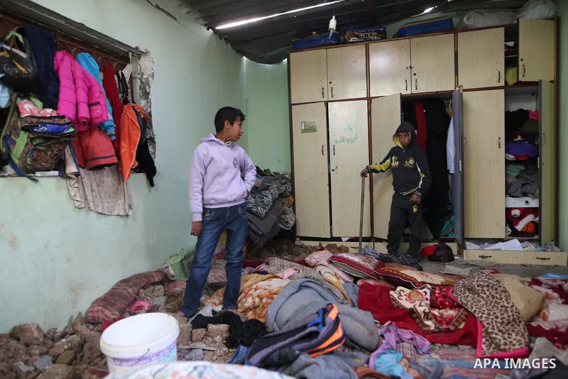 Palestinian boys inspect a bedroom of the damaged Khussa family home after an Israeli strike on Hamas bases in Beit Lahiya, northern Gaza strip on March 12, 2016. Israeli planes struck Hamas bases in the Gaza Strip early...