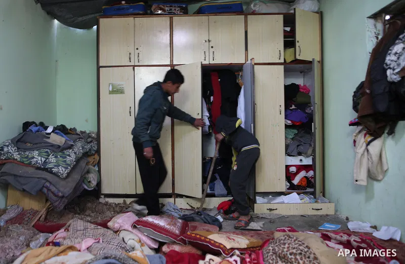 Palestinian boys inspect a bedroom of the damaged Khussa family home after an Israeli strike on Hamas bases in Beit Lahiya, northern Gaza strip on March 12, 2016. Israeli planes struck Hamas bases in the Gaza Strip early...