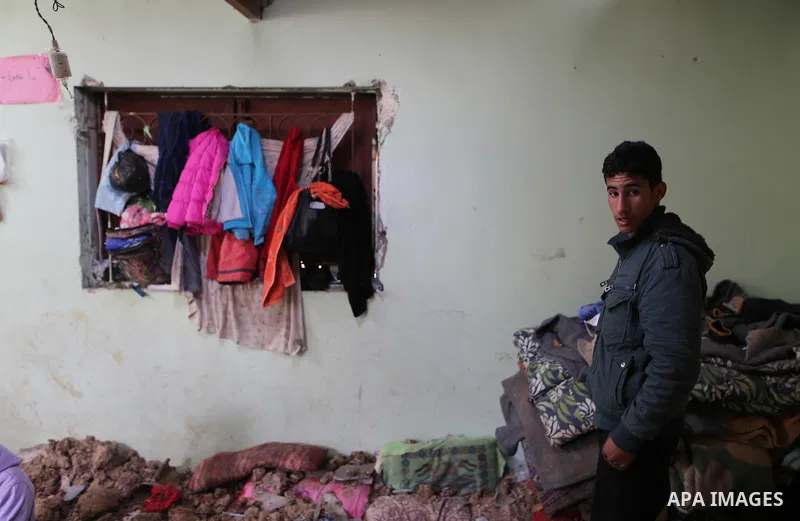 A Palestinian boy inspects a bedroom of the damaged Khussa family home after an Israeli strike on Hamas bases in Beit Lahiya, northern Gaza strip on March 12, 2016. Israeli planes struck Hamas bases in the Gaza Strip ear...