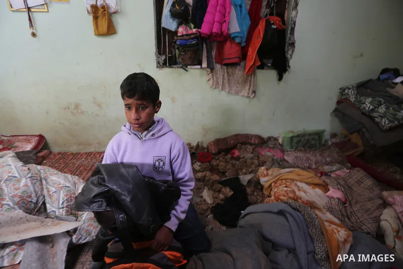 A Palestinian boy inspects a bedroom of the damaged Khussa family home after an Israeli strike on Hamas bases in Beit Lahiya, northern Gaza strip on March 12, 2016. Israeli planes struck Hamas bases in the Gaza Strip ear...