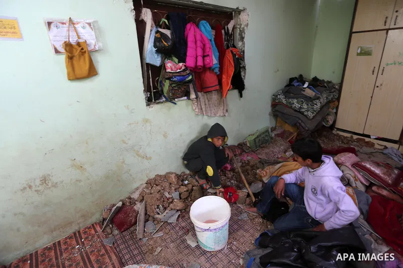 Palestinian boys inspect a bedroom of the damaged Khussa family home after an Israeli strike on Hamas bases in Beit Lahiya, northern Gaza strip on March 12, 2016. Israeli planes struck Hamas bases in the Gaza Strip early...