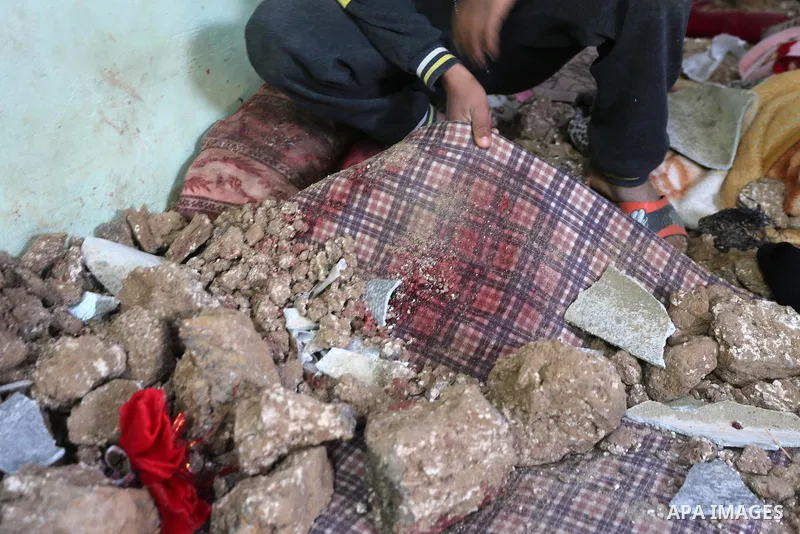 A Palestinian boy inspects a bedroom of the damaged Khussa family home after an Israeli strike on Hamas bases in Beit Lahiya, northern Gaza strip on March 12, 2016. Israeli planes struck Hamas bases in the Gaza Strip ear...