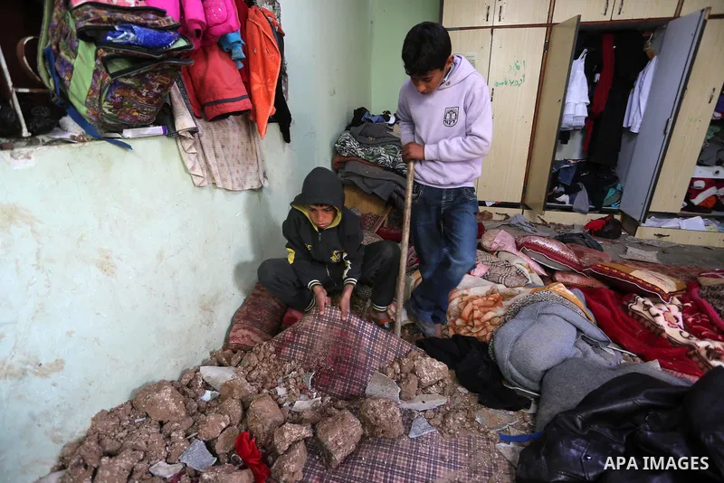 A Palestinian boy inspects a bedroom of the damaged Khussa family home after an Israeli strike on Hamas bases in Beit Lahiya, northern Gaza strip on March 12, 2016. Israeli planes struck Hamas bases in the Gaza Strip ear...