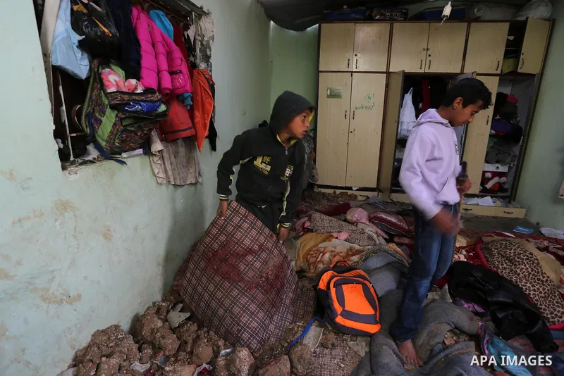 Palestinian boys inspect a bedroom of the damaged Khussa family home after an Israeli strike on Hamas bases in Beit Lahiya, northern Gaza strip on March 12, 2016. Israeli planes struck Hamas bases in the Gaza Strip early...