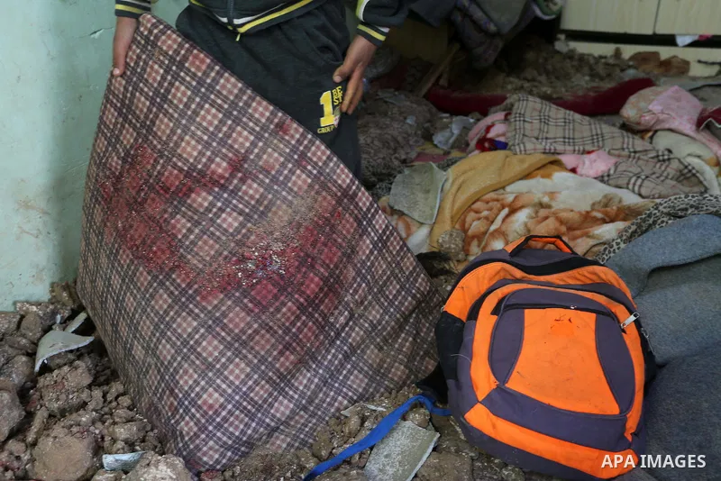 A Palestinian boy inspects a bedroom of the damaged Khussa family home after an Israeli strike on Hamas bases in Beit Lahiya, northern Gaza strip on March 12, 2016. Israeli planes struck Hamas bases in the Gaza Strip ear...