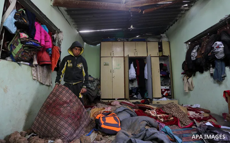 A Palestinian boy inspects a bedroom of the damaged Khussa family home after an Israeli strike on Hamas bases in Beit Lahiya, northern Gaza strip on March 12, 2016. Israeli planes struck Hamas bases in the Gaza Strip ear...