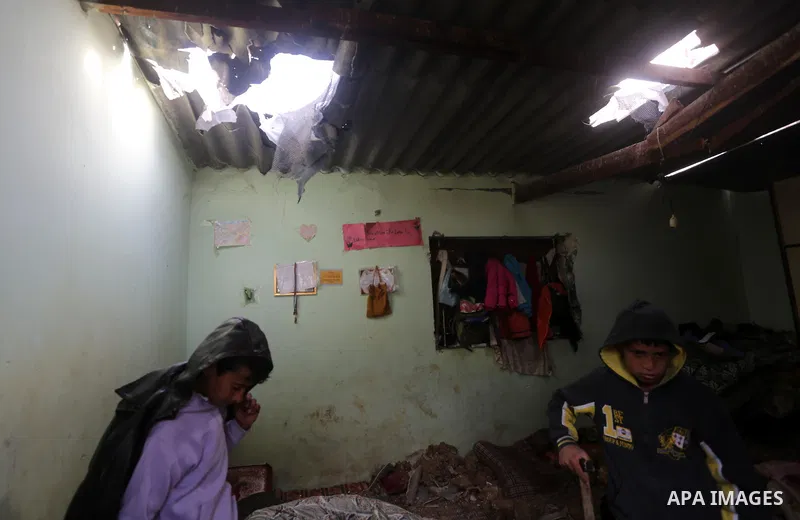 Palestinian boys inspect a bedroom of the damaged Khussa family home after an Israeli strike on Hamas bases in Beit Lahiya, northern Gaza strip on March 12, 2016. Israeli planes struck Hamas bases in the Gaza Strip early...