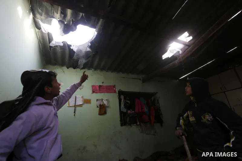Palestinian boys inspect a bedroom of the damaged Khussa family home after an Israeli strike on Hamas bases in Beit Lahiya, northern Gaza strip on March 12, 2016. Israeli planes struck Hamas bases in the Gaza Strip early...