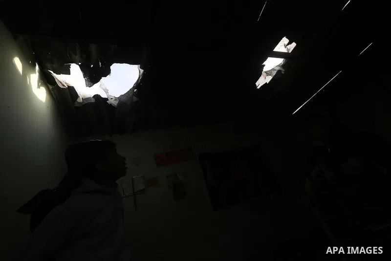 A Palestinian boy inspects a bedroom of the damaged Khussa family home after an Israeli strike on Hamas bases in Beit Lahiya, northern Gaza strip on March 12, 2016. Israeli planes struck Hamas bases in the Gaza Strip ear...