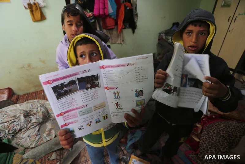 Palestinian boys inspect a bedroom of the damaged Khussa family home after an Israeli strike on Hamas bases in Beit Lahiya, northern Gaza strip on March 12, 2016. Israeli planes struck Hamas bases in the Gaza Strip early...