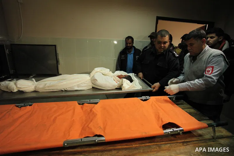 The body of Palestinian Yasin Abu Khussa, 10, lies on the bed in the morgue of a hospital following an Israeli air strike in the northern Gaza strip on March 12, 2016. Israeli planes struck Hamas bases in the Gaza Strip...