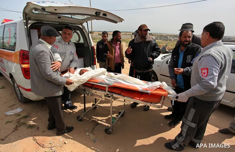 Mourners carry the body of Palestinian Yasin Abu Khussa, 10, during his funeral in the northern Gaza strip on March 12, 2016. Israeli planes struck Hamas bases in the Gaza Strip early on March 12, killing a child living...