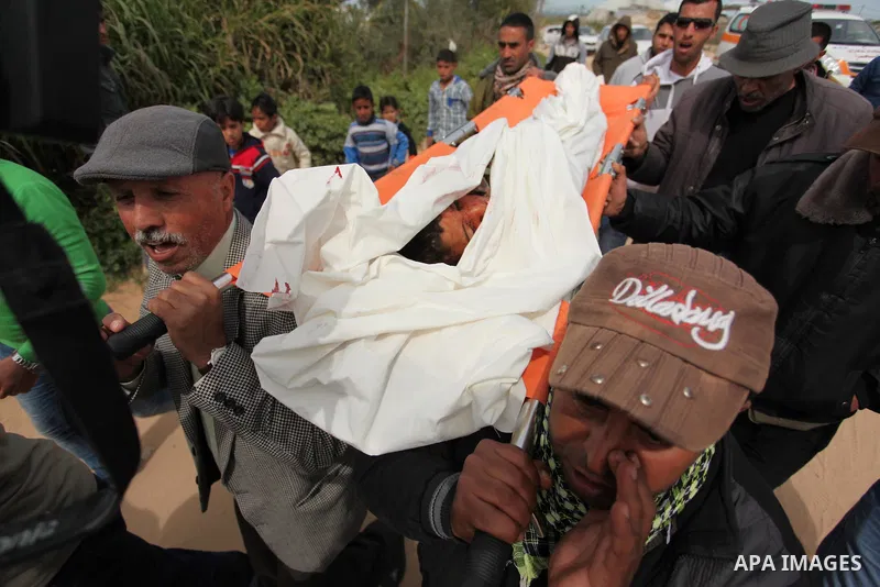 Mourners carry the body of Palestinian Yasin Abu Khussa, 10, during his funeral in the northern Gaza strip on March 12, 2016. Israeli planes struck Hamas bases in the Gaza Strip early on March 12, killing a child living...