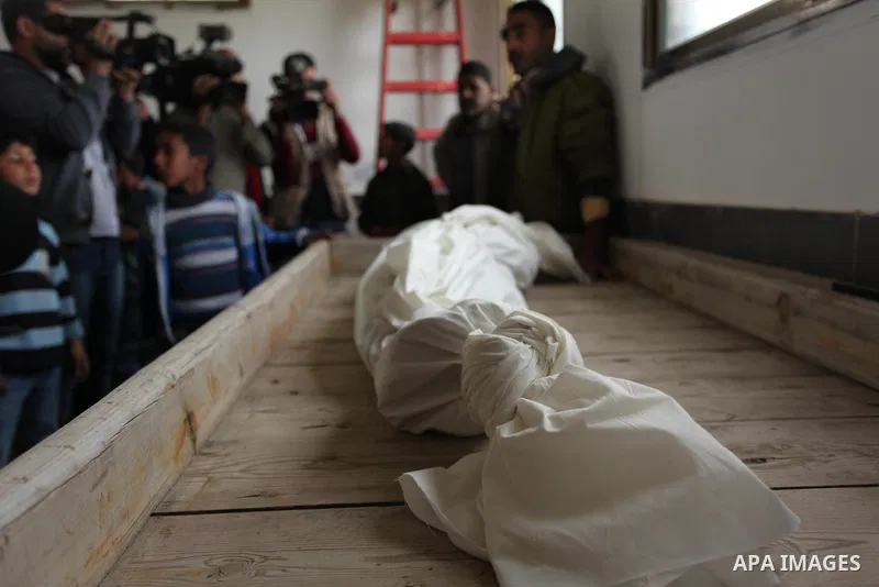 Mourners gather around the body of Palestinian Yasin Abu Khussa, 10, during his funeral in the northern Gaza strip on March 12, 2016. Israeli planes struck Hamas bases in the Gaza Strip early on March 12, killing a child...