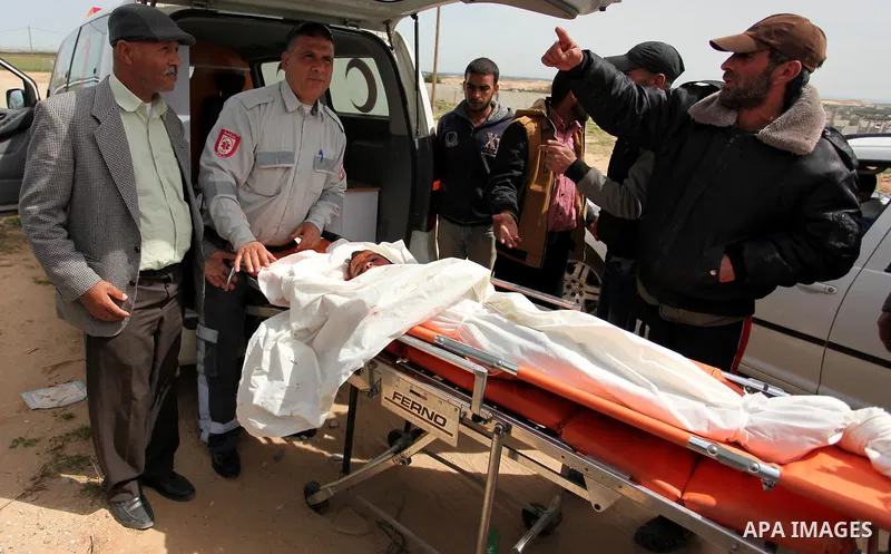 Mourners carry the body of Palestinian Yasin Abu Khussa, 10, during his funeral in the northern Gaza strip on March 12, 2016. Israeli planes struck Hamas bases in the Gaza Strip early on March 12, killing a child living...