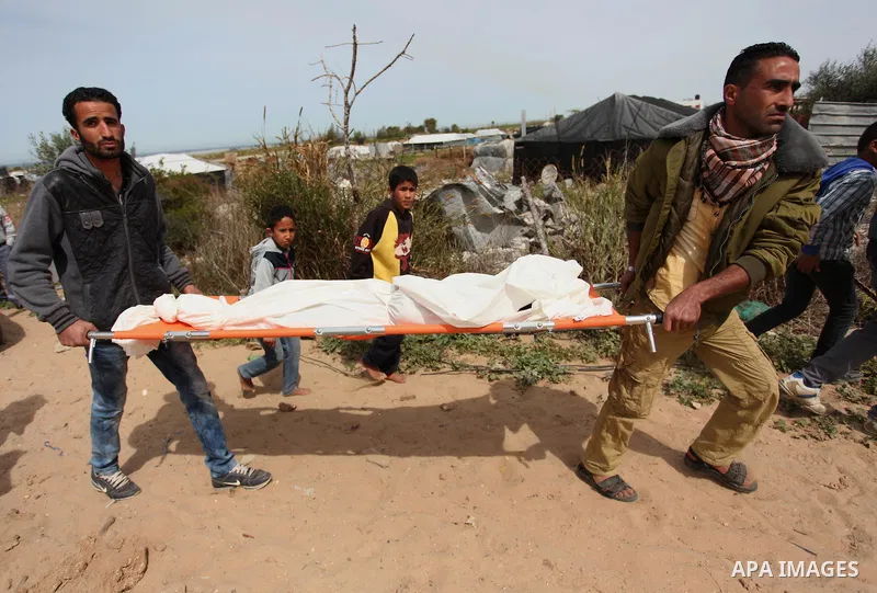 Mourners carry the body of Palestinian Yasin Abu Khussa, 10, during his funeral in the northern Gaza strip on March 12, 2016. Israeli planes struck Hamas bases in the Gaza Strip early on March 12, killing a child living...