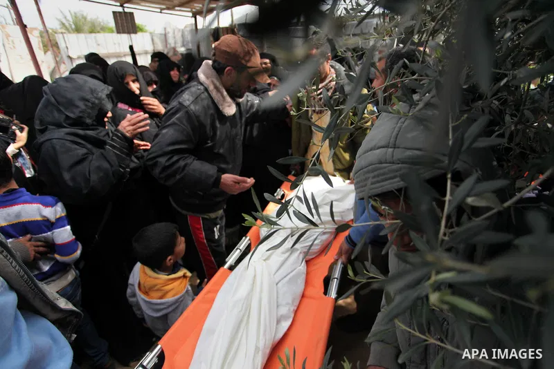 Mourners carry the body of Palestinian Yasin Abu Khussa, 10, during his funeral in the northern Gaza strip on March 12, 2016. Israeli planes struck Hamas bases in the Gaza Strip early on March 12, killing a child living...