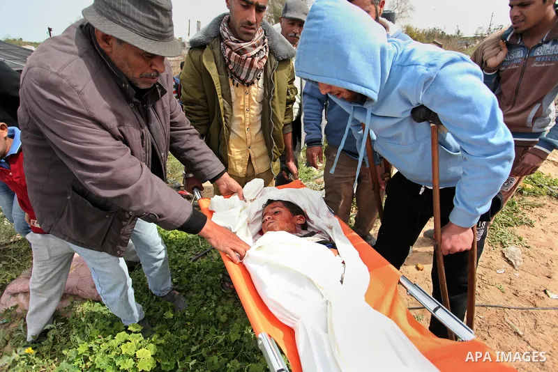 Mourners carry the body of Palestinian Yasin Abu Khussa, 10, during his funeral in the northern Gaza strip on March 12, 2016. Israeli planes struck Hamas bases in the Gaza Strip early on March 12, killing a child living...