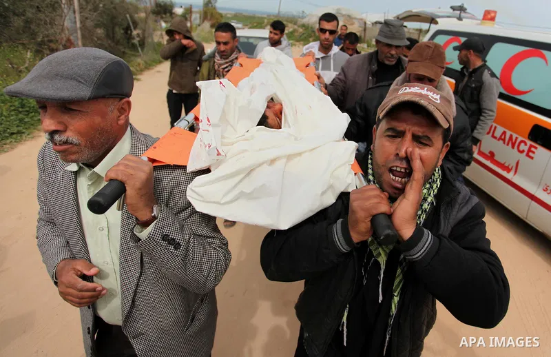 Mourners carry the body of Palestinian Yasin Abu Khussa, 10, during his funeral in the northern Gaza strip on March 12, 2016. Israeli planes struck Hamas bases in the Gaza Strip early on March 12, killing a child living...