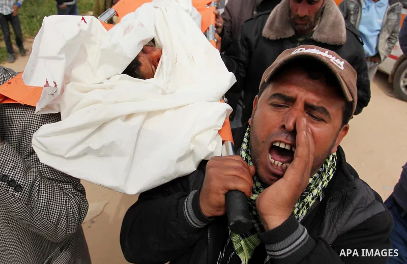 Mourners carry the body of Palestinian Yasin Abu Khussa, 10, during his funeral in the northern Gaza strip on March 12, 2016. Israeli planes struck Hamas bases in the Gaza Strip early on March 12, killing a child living...