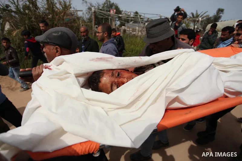 Mourners carry the body of Palestinian Yasin Abu Khussa, 10, during his funeral in the northern Gaza strip on March 12, 2016. Israeli planes struck Hamas bases in the Gaza Strip early on March 12, killing a child living...