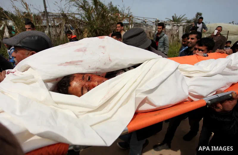 Mourners carry the body of Palestinian Yasin Abu Khussa, 10, during his funeral in the northern Gaza strip on March 12, 2016. Israeli planes struck Hamas bases in the Gaza Strip early on March 12, killing a child living...