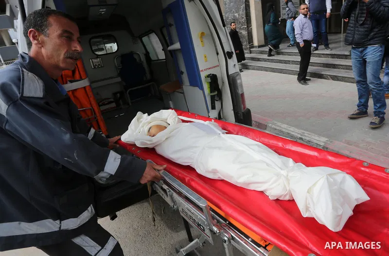 The body of Palestinian Israa Abu Khussa, 6, lies on the bed at the morgue of El-shifa hospital following an Israeli air strike following an Israeli air strike in the northern Gaza strip on March 12, 2016. Israeli planes...