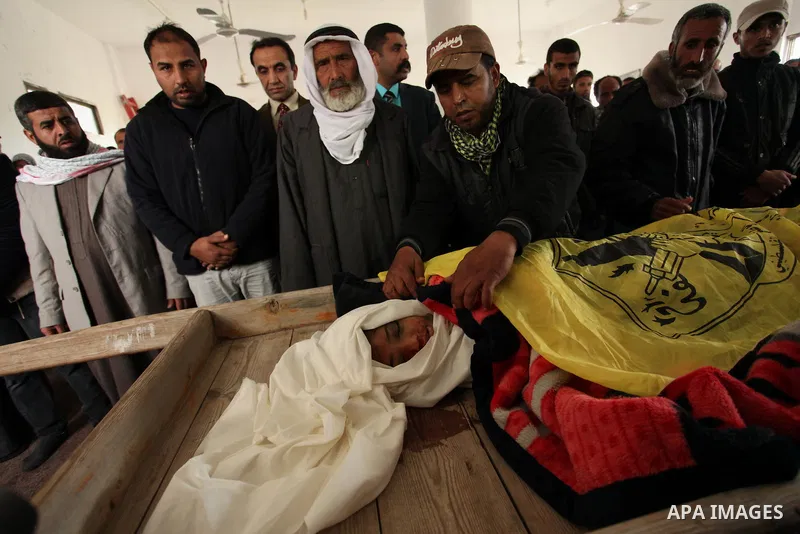 Palestinian mourners carry the body of Israa Abu Khussa, 6, during her funeral on March 12, 2016 in Beit Lahiya in the north of the Gaza strip. Israeli planes struck the bases of the Hamas group's military wing, the Ezze...