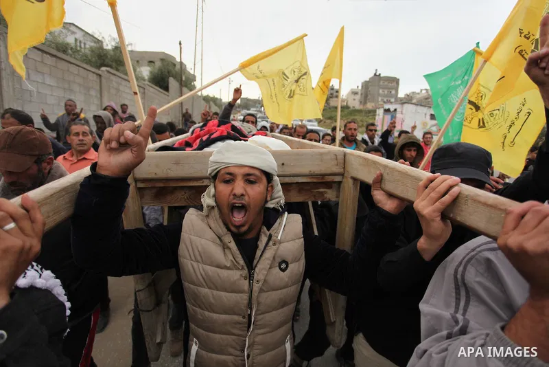 Palestinian mourners carry the body of Israa Abu Khussa, 6, during her funeral on March 12, 2016 in Beit Lahiya in the north of the Gaza strip. Israeli planes struck the bases of the Hamas group's military wing, the Ezze...