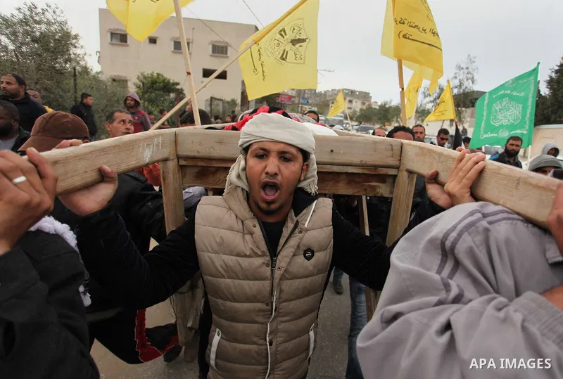 Palestinian mourners carry the body of Israa Abu Khussa, 6, during her funeral on March 12, 2016 in Beit Lahiya in the north of the Gaza strip. Israeli planes struck the bases of the Hamas group's military wing, the Ezze...