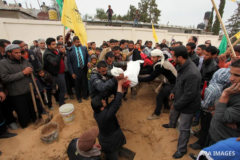 Palestinian mourners burry the body of Israa Abu Khussa, 6, during her funeral on March 12, 2016 in Beit Lahiya in the north of the Gaza strip. Israeli planes struck the bases of the Hamas group's military wing, the Ezze...