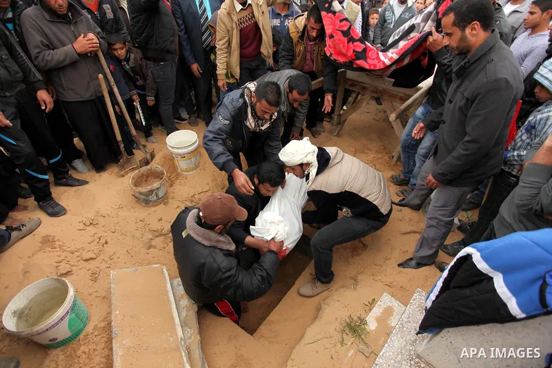 Palestinian mourners burry the body of Israa Abu Khussa, 6, during her funeral on March 12, 2016 in Beit Lahiya in the north of the Gaza strip. Israeli planes struck the bases of the Hamas group's military wing, the Ezze...