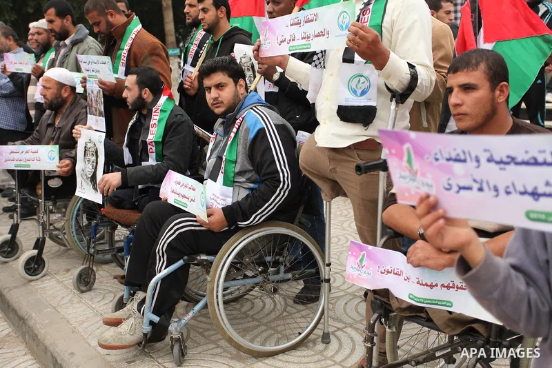 Palestinian Woundeds take part in a rally on the occasion of the Palestinian Wounded's Day in Gaza City on March 13, 2016. Photo by Ashraf Amra