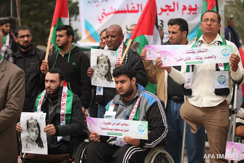Palestinian Woundeds take part in a rally on the occasion of the Palestinian Wounded's Day in Gaza City on March 13, 2016. Photo by Ashraf Amra