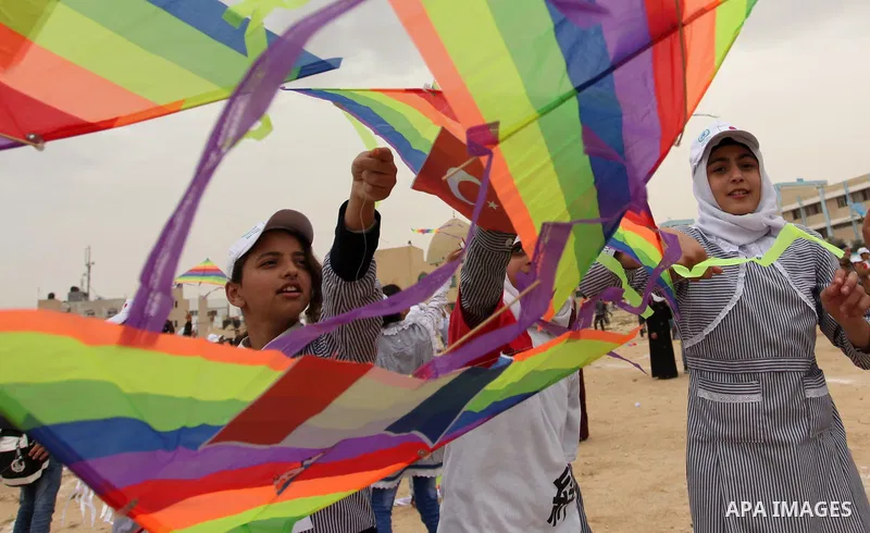 Palestinian children fly kites to show their solidarity with the Japanese people near the Japan-funded housing project in Khan Younis in the southern Gaza Strip March 13, 2016. The event was organised by the United Natio...