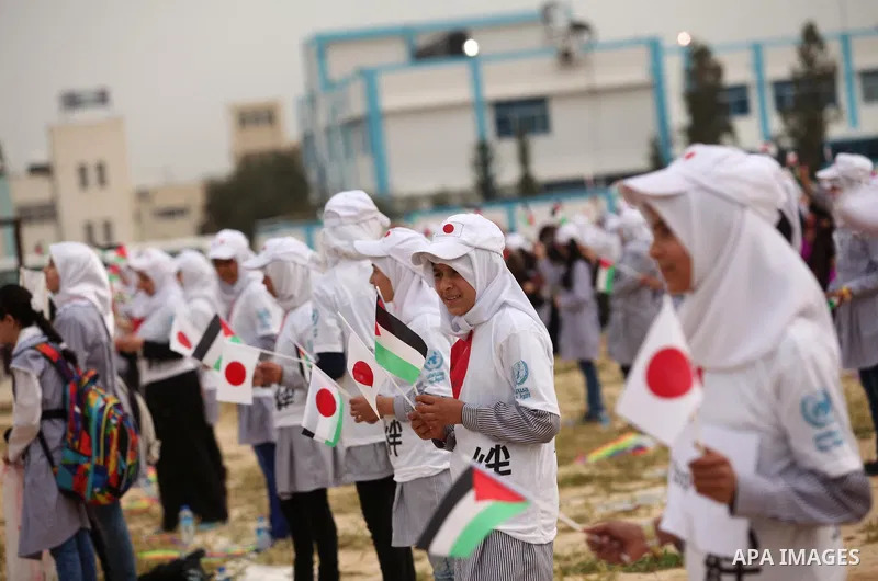 Palestinian children fly kites to show their solidarity with the Japanese people near the Japan-funded housing project in Khan Younis in the southern Gaza Strip March 13, 2016. The event was organised by the United Natio...