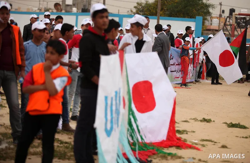 Palestinian children fly kites to show their solidarity with the Japanese people near the Japan-funded housing project in Khan Younis in the southern Gaza Strip March 13, 2016. The event was organised by the United Natio...