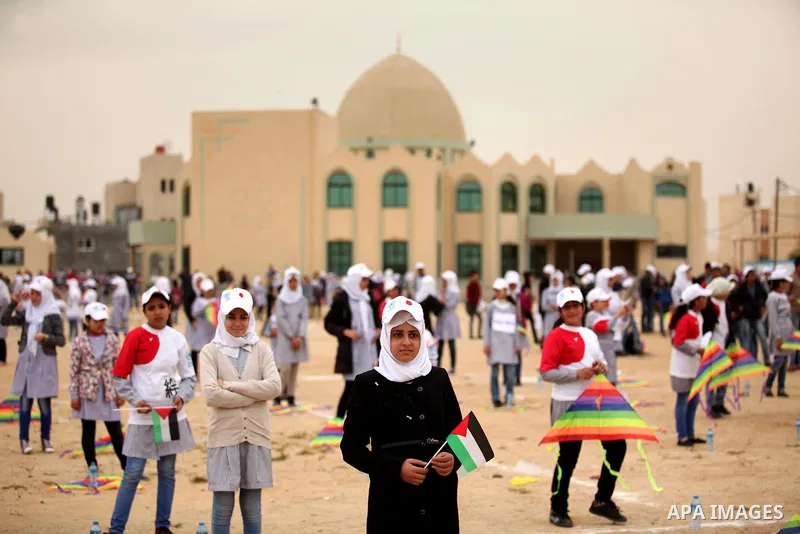 Palestinian children fly kites to show their solidarity with the Japanese people near the Japan-funded housing project in Khan Younis in the southern Gaza Strip March 13, 2016. The event was organised by the United Natio...
